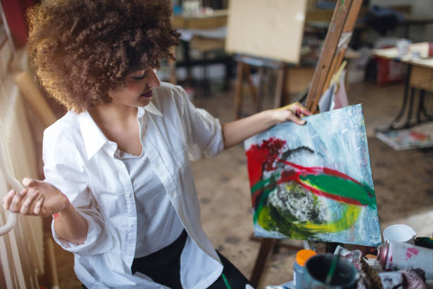 istock Woman with her painting 890109788