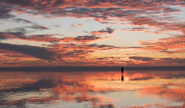 istock Photographer  having fun with Drone on salt lake at sunset 890115066
