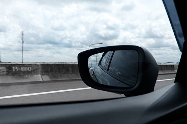 istock High Way Road and Cloudy Sky Seen Through Car Windows, and Side Mirror 890115580