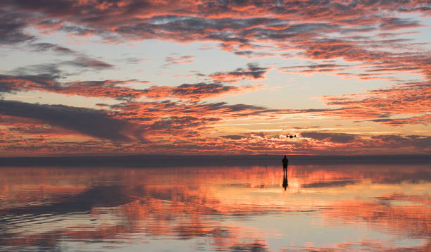 istock Photographer  having fun with Drone on salt lake at sunset 890115628