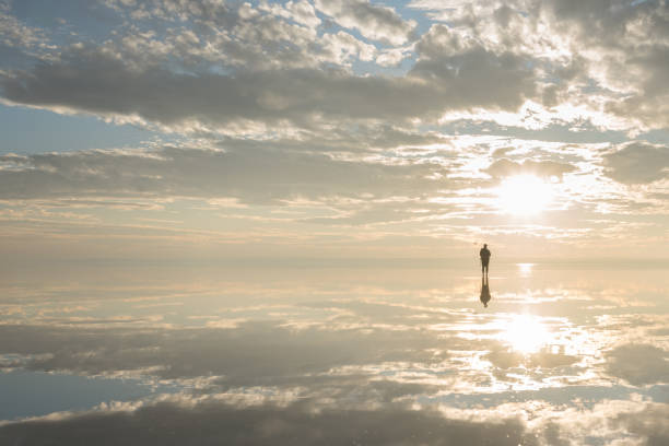 istock Photographer  having fun with Drone on salt lake at sunset 890115738