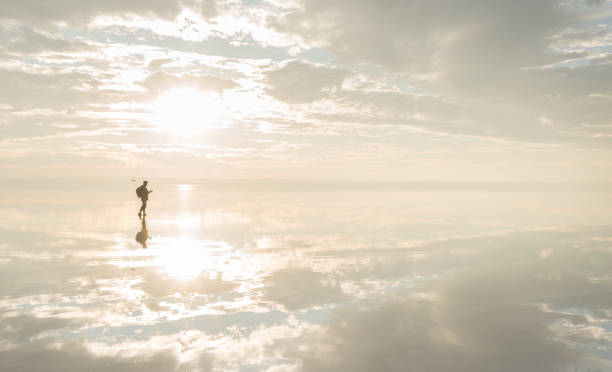 istock Photographer  having fun with Drone on salt lake at sunset 890118192