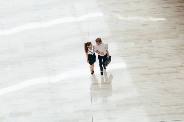 istock Business couple walking together 890120770