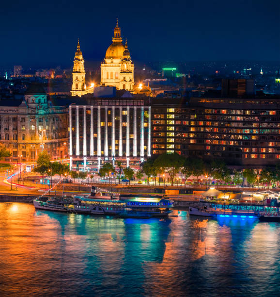 Picturesque cityscape of centered Saint Stephen's Basilica (St Istvan's) church Picturesque cityscape of centered Saint Stephen's Basilica (St Istvan's) church and Danube river. Colorful night scene in Budapest, Hungary, Europe. Artistic style post processed photo. budapest danube river cruise hungary stock pictures, royalty-free photos & images