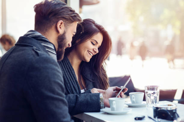 istock Young couple watching on the mobile phone 890121030