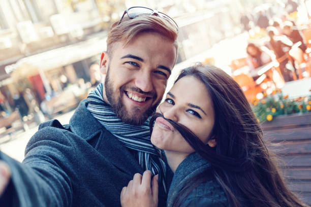 istock Happy couple making selfies on the street 890121034