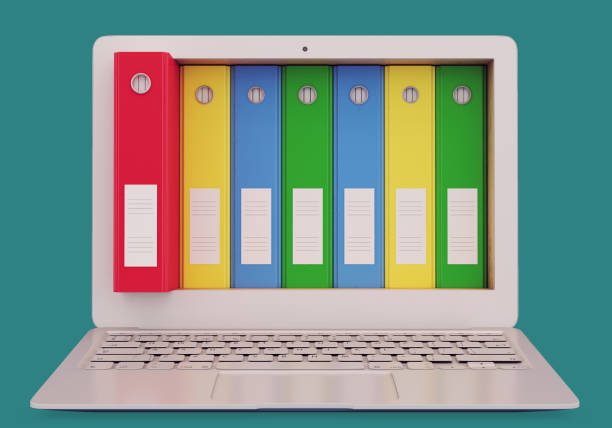 istock Laptop with colorful office folders 890135606