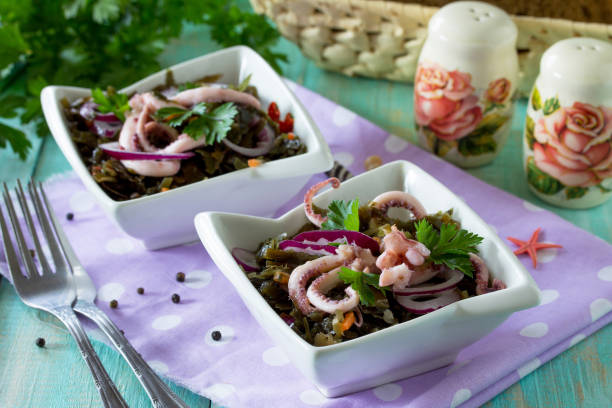 istock Homemade snacks on the festive table. Salad with octopus and sea cabbage. 890144468