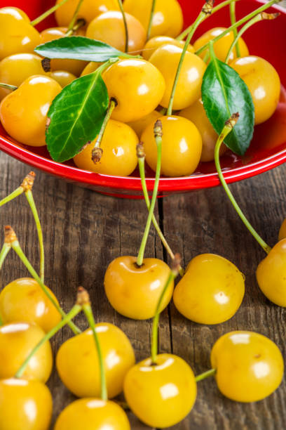istock Yellow cherry in bowl on a wooden background 890153968