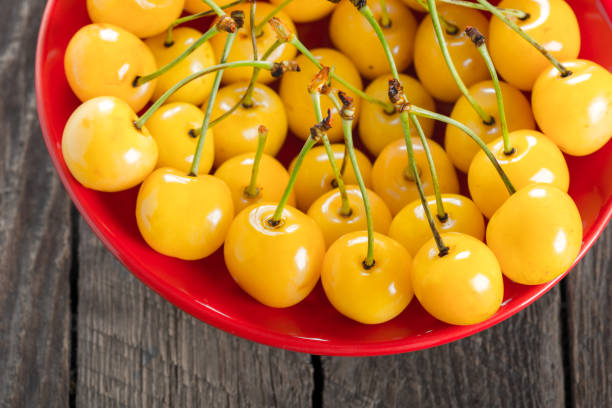 istock Yellow cherry in bowl on a wooden background 890154992