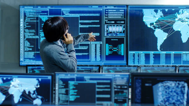 istock In the System Control Room IT Administrator Talks on the Phone. He's in a High-Tech Facility That Works on the Surveillance, Neural Networks, Data Mining, AI Projects. 890155032