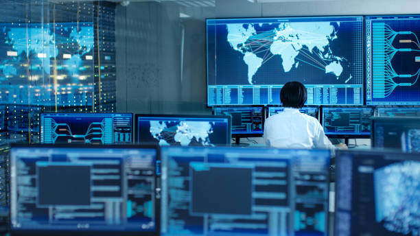 istock In the System Control Room Operator Sits at His Workstation with Multiple Displays Showing Graphics and Logistics Information. 890155102
