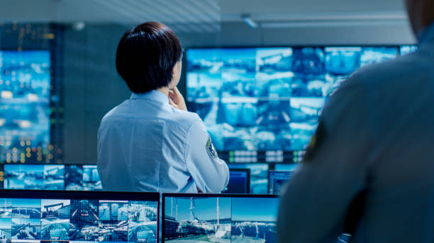 istock In the Security Control Room Officer Monitors Multiple Screens for Suspicious Activities. He Guards Internationally Important Logistics Facility. 890157232