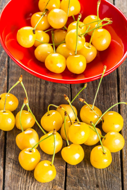 istock Yellow cherry in bowl on a wooden background 890157244