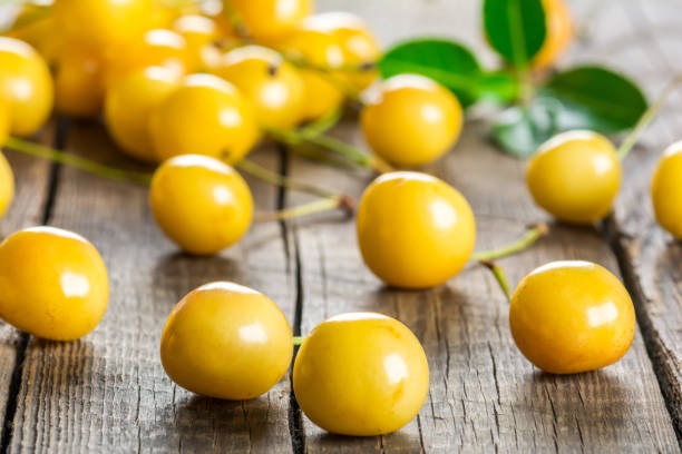 istock Yellow cherry on a wooden background 890157492
