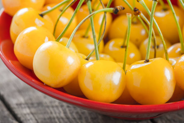 istock Yellow cherry in bowl on a wooden background 890157644