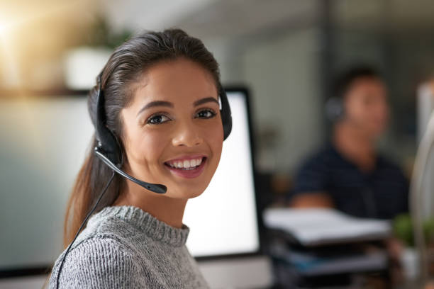 How may they help you? Shot of young agents working in a call center reduction looking at camera finance business stock pictures, royalty-free photos & images