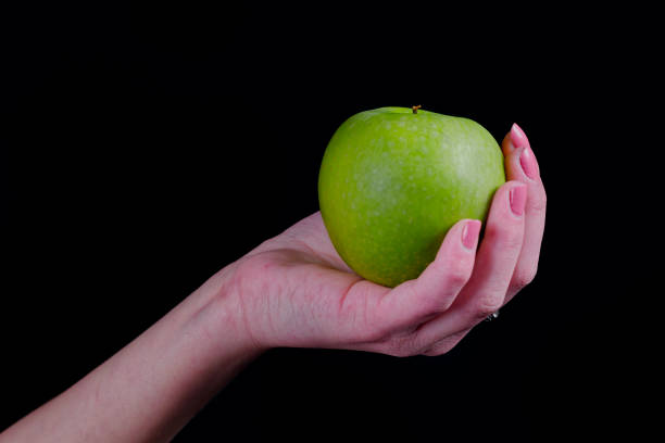 istock Green apple in girl hand 890173956