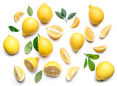 Ripe lemons and lemon leaves.