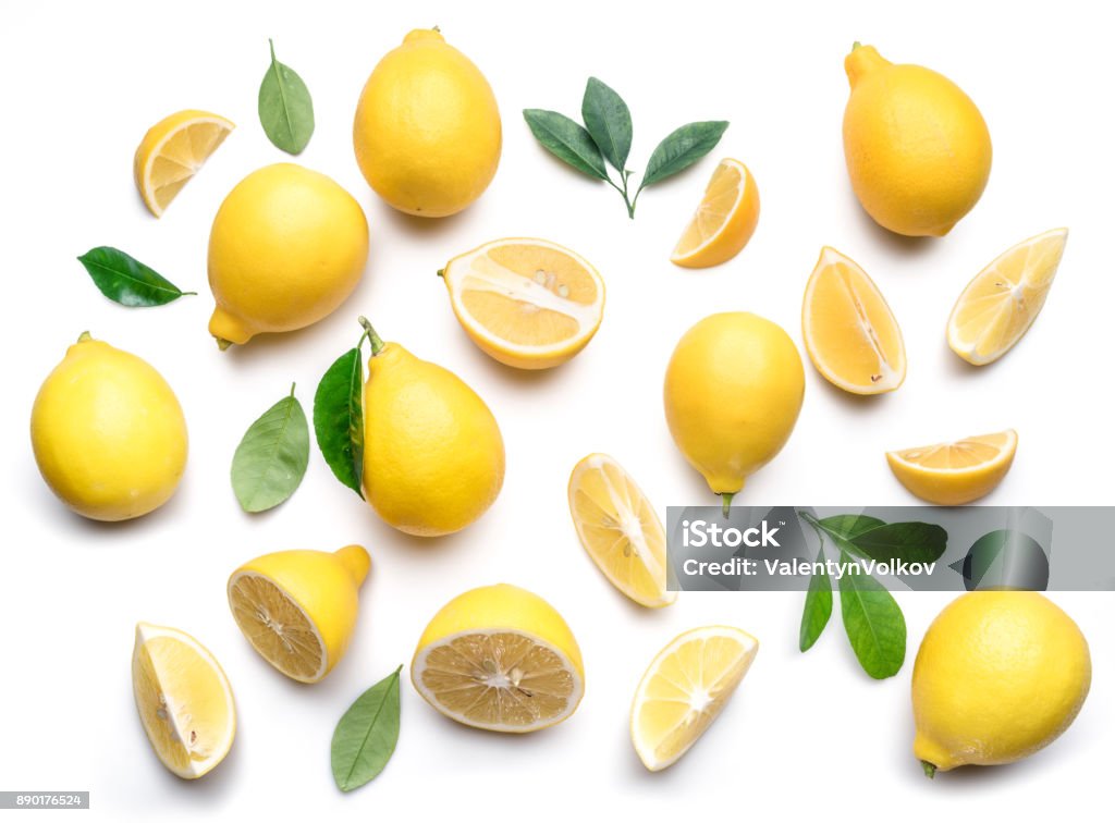 Ripe lemons and lemon leaves. Ripe lemons and lemon leaves on white background. Top view. Lemon - Fruit Stock Photo