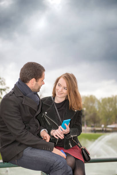 istock Young romantic french couple having a date at Eiffel tower fountain 890183680