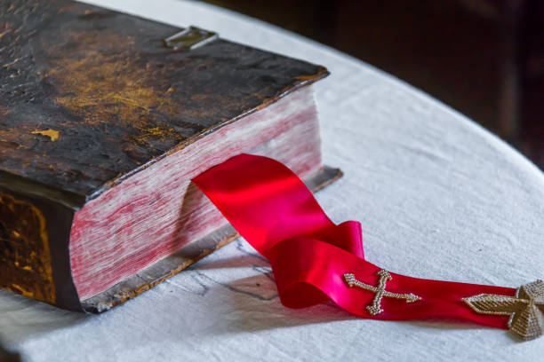 istock Old ancient Bible with a red ribbon 890189112