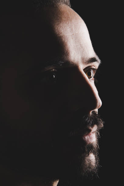 istock Portrait of man in dark background 890198474