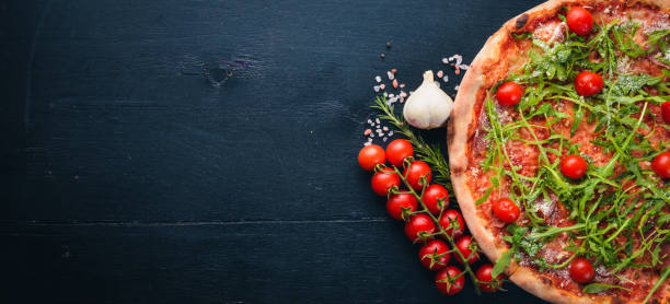 istock Pizza Primavera. Cherry tomatoes, arugula, cheese. On a wooden background. Top view. 890199114