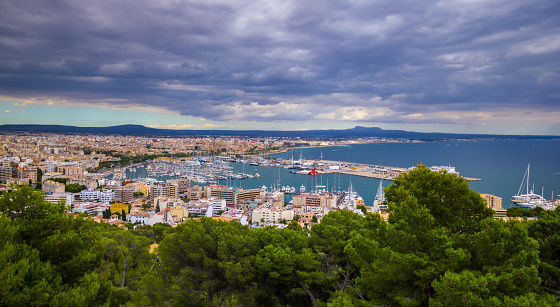 View on Palma de Mallorca city aerial from Bellver Castle. Dramatic clouds.