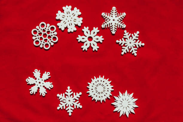 istock Snowflakes on a red background. Christmas toy drive. 890204688