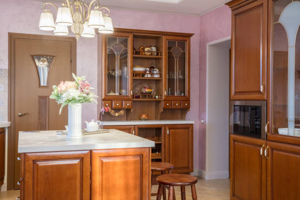 istock cupboard in  light classic kitchen and vase with flowers on  table 890205492