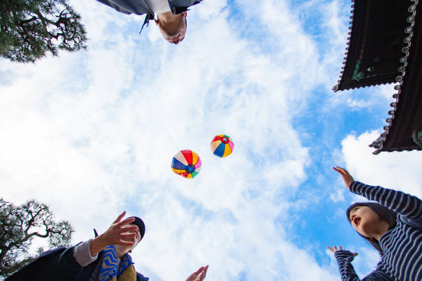 Family playing with paper balloon