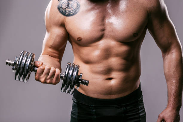 Biceps workout Athlete work on his biceps with kettlebell wrestlers uniform stock pictures, royalty-free photos & images