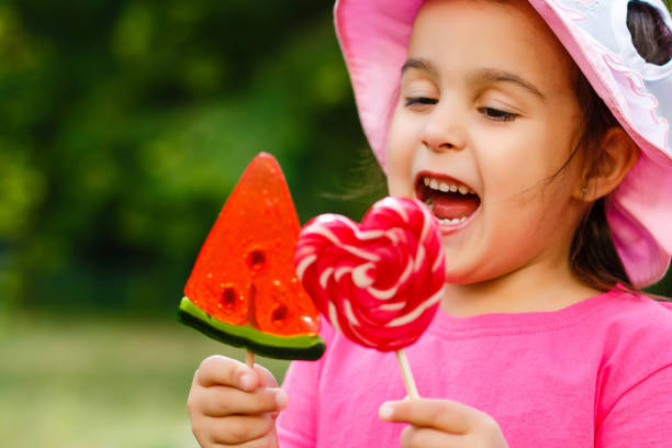 Close-up of a child holding christmas sweets outdoors