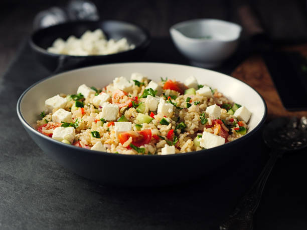 Healthy fluffy brown rice and chopped herbs salad