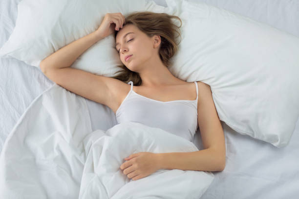istock Woman sleeping in bed. 890221456