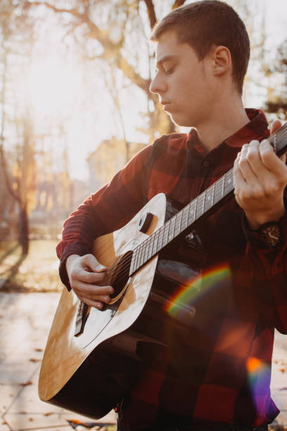 istock Young teenager plays guitar 890221802