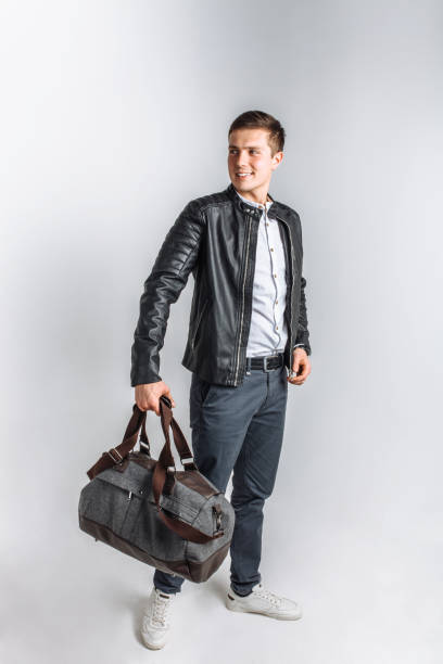 istock Man goes on a journey. The guy in the Studio. The guy in the black jacket. Handsome guy 890221874