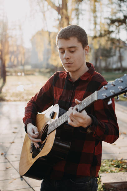 istock Young teenager plays guitar 890226346
