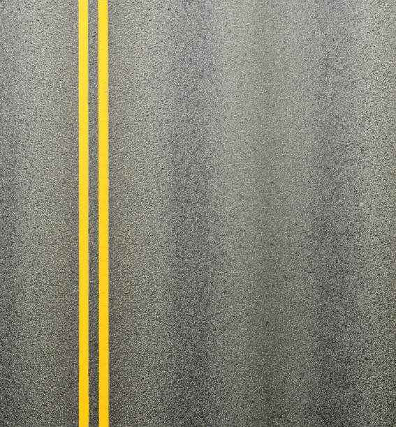 asfaltowa droga i podwójne żółte linie dzielące pasy ruchu. - middle of road zdjęcia i obrazy z banku zdjęć