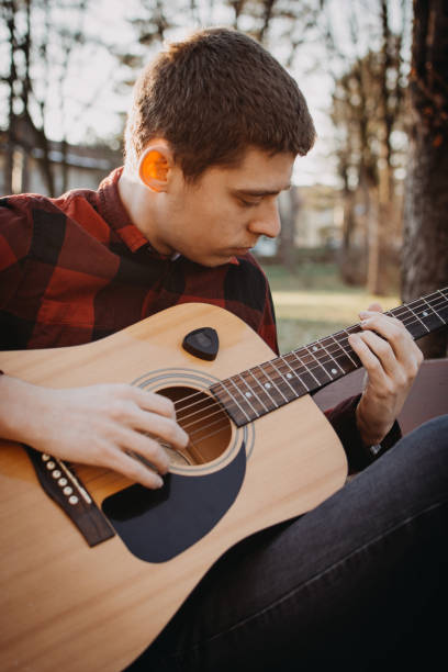 istock Young teenager plays guitar 890233636