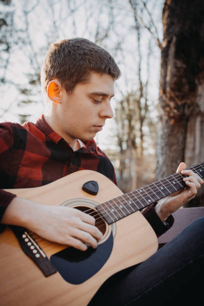 istock Young teenager plays guitar 890233830