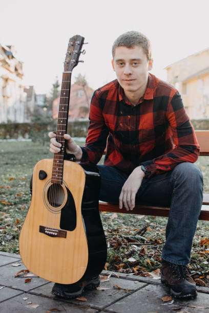 istock Young teenager plays guitar 890234296