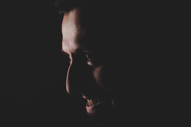istock Portrait of strange man on black backround 890239034