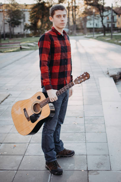 istock Young teenager plays guitar 890240118