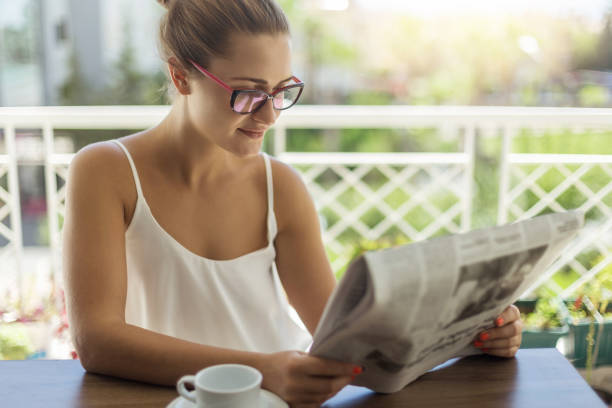 istock Woman reading newspaper 890254950