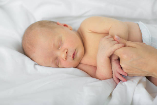 istock The newborn falls asleep in the mother's hands. 890255012