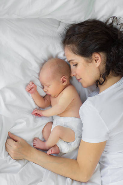 istock The newborn sleeps with the mother. 890255118