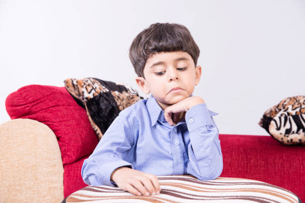 istock Arabic child sitting at home sad 890257594