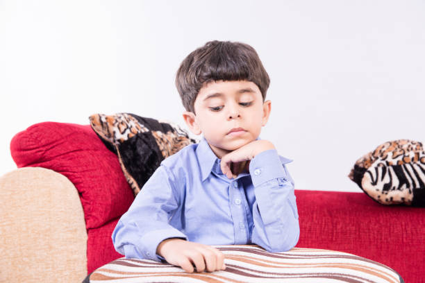 istock Arabic child sitting at home sad 890257598